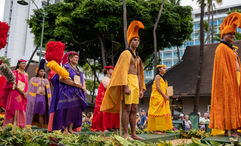 Members of the Aloha Festivals’ royal court take part in the 2022 Aloha Festivals Floral Parade. They are dressed in cloaks and helmets that were commonly worn by Hawaii’s chiefs.