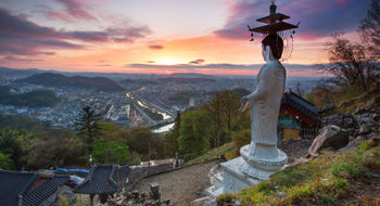 Buddhist statue towers over temple in South Korea, a new destination Contiki will offer in 2024.