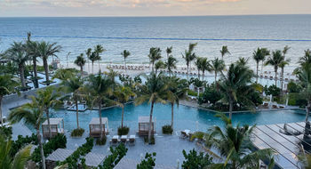 The pool deck of the Waldorf Astoria Cancun is peppered with palm trees and offers some gorgeous sea views.