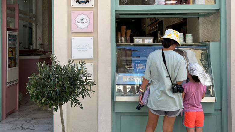 Young travelers outside a gelato and pastry shop in Nafplio, Greece. With record-breaking temperatures in Southern Europe, travelers are looking for ways to stay cool.